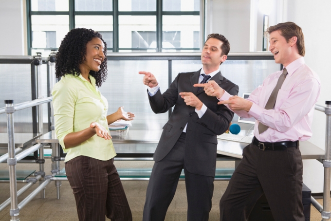 Businessmen congratulating businesswoman